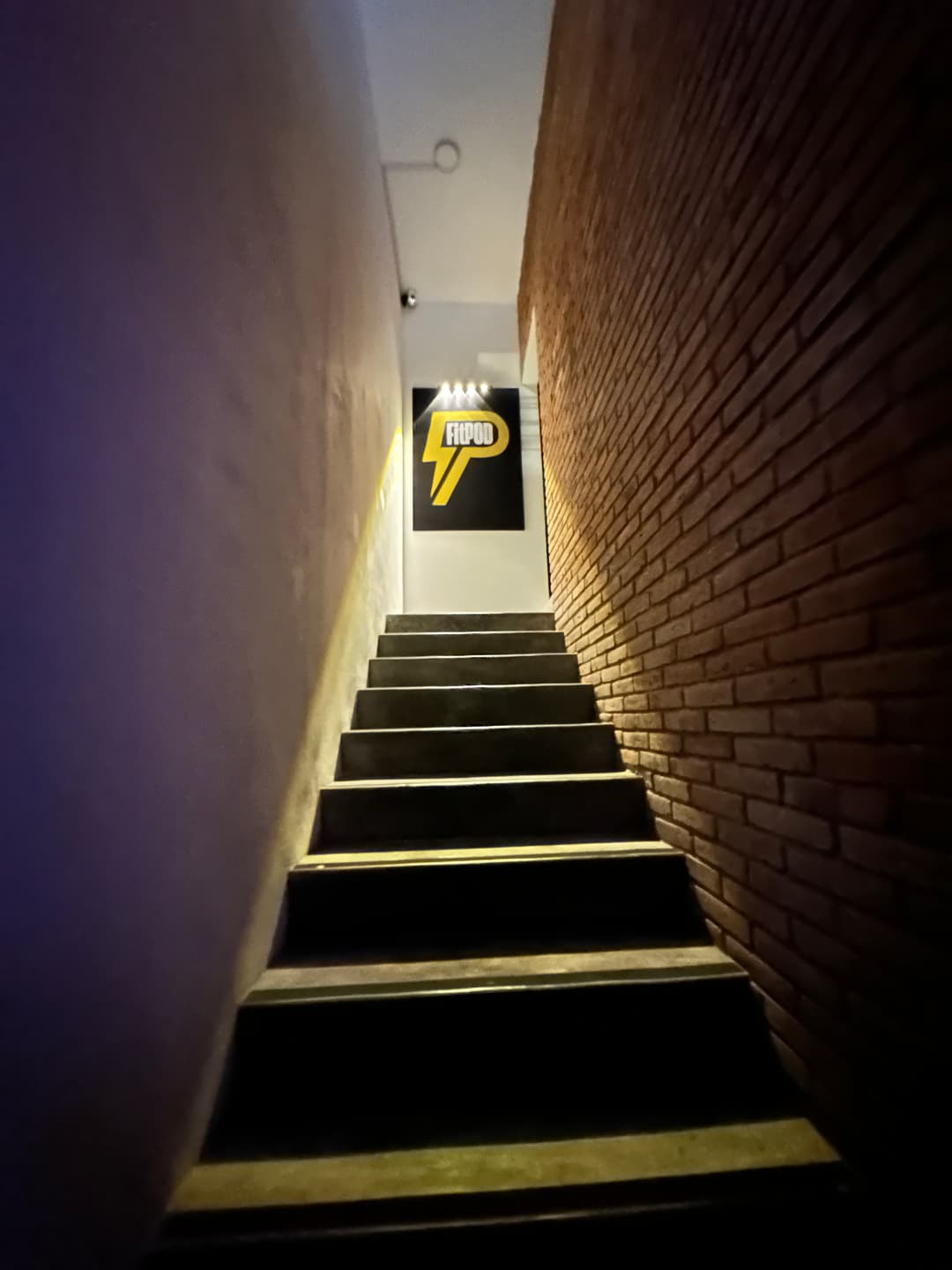 Interior stairs with the FitPOD logo at the end