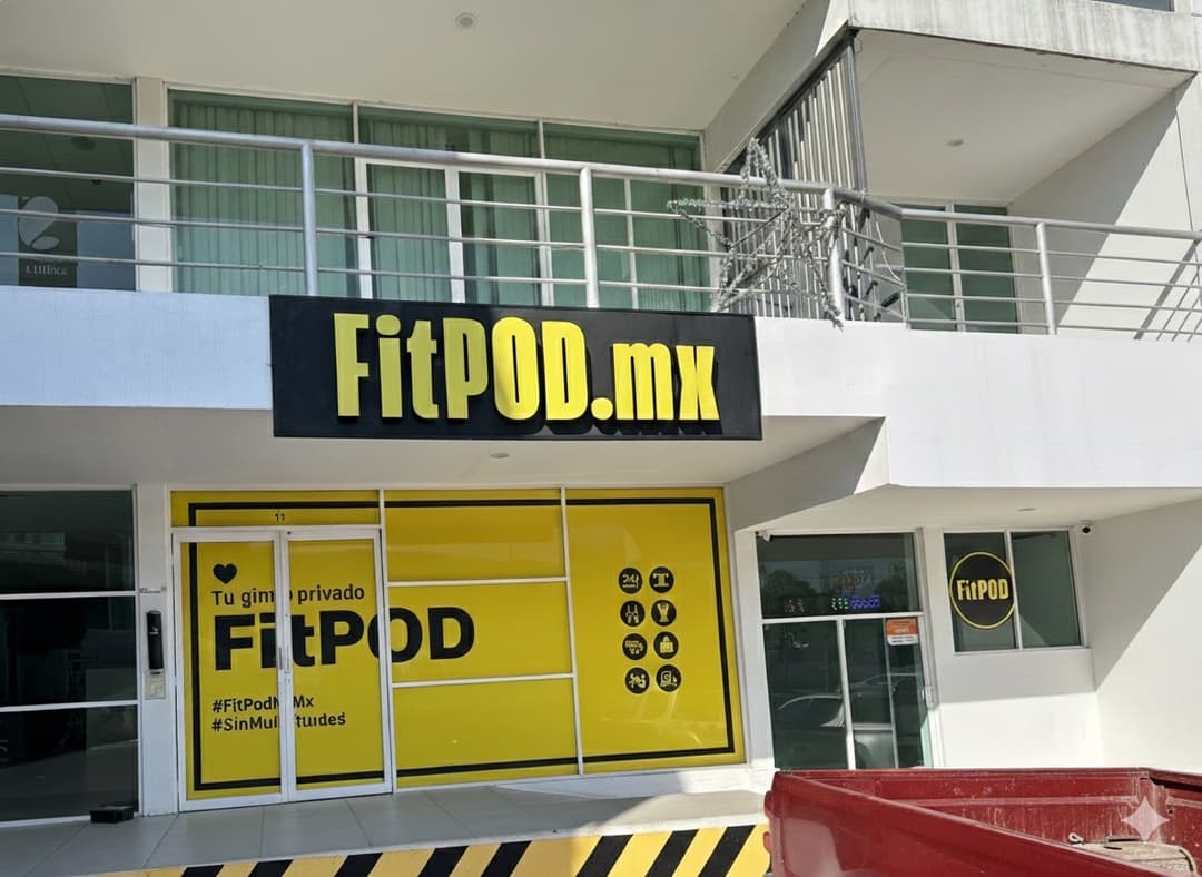 Real front of Vista Real with yellow windows and the FitPOD.mx sign