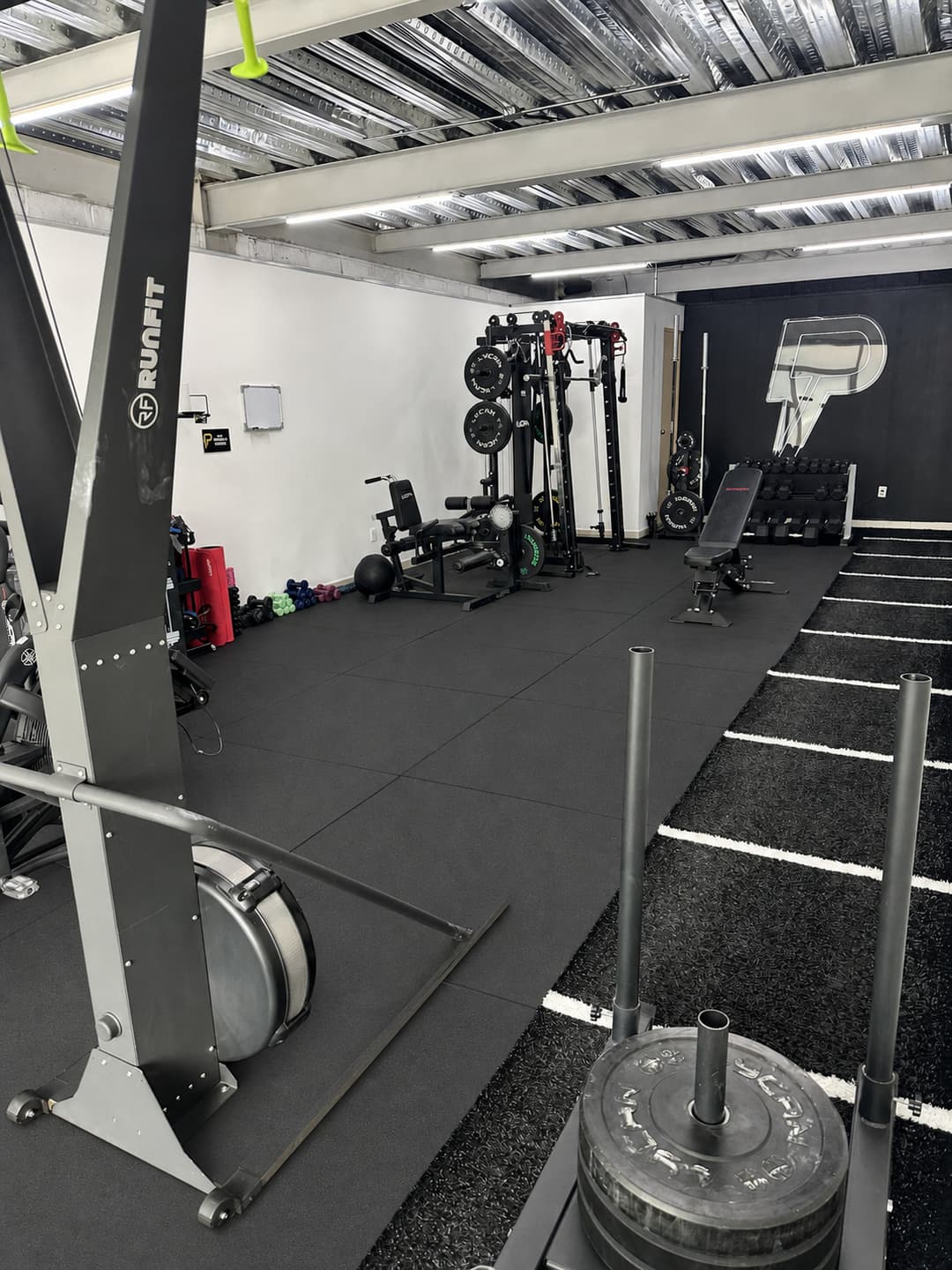 Strength equipment at Vista Real, with SkiErg and sled in the foreground
