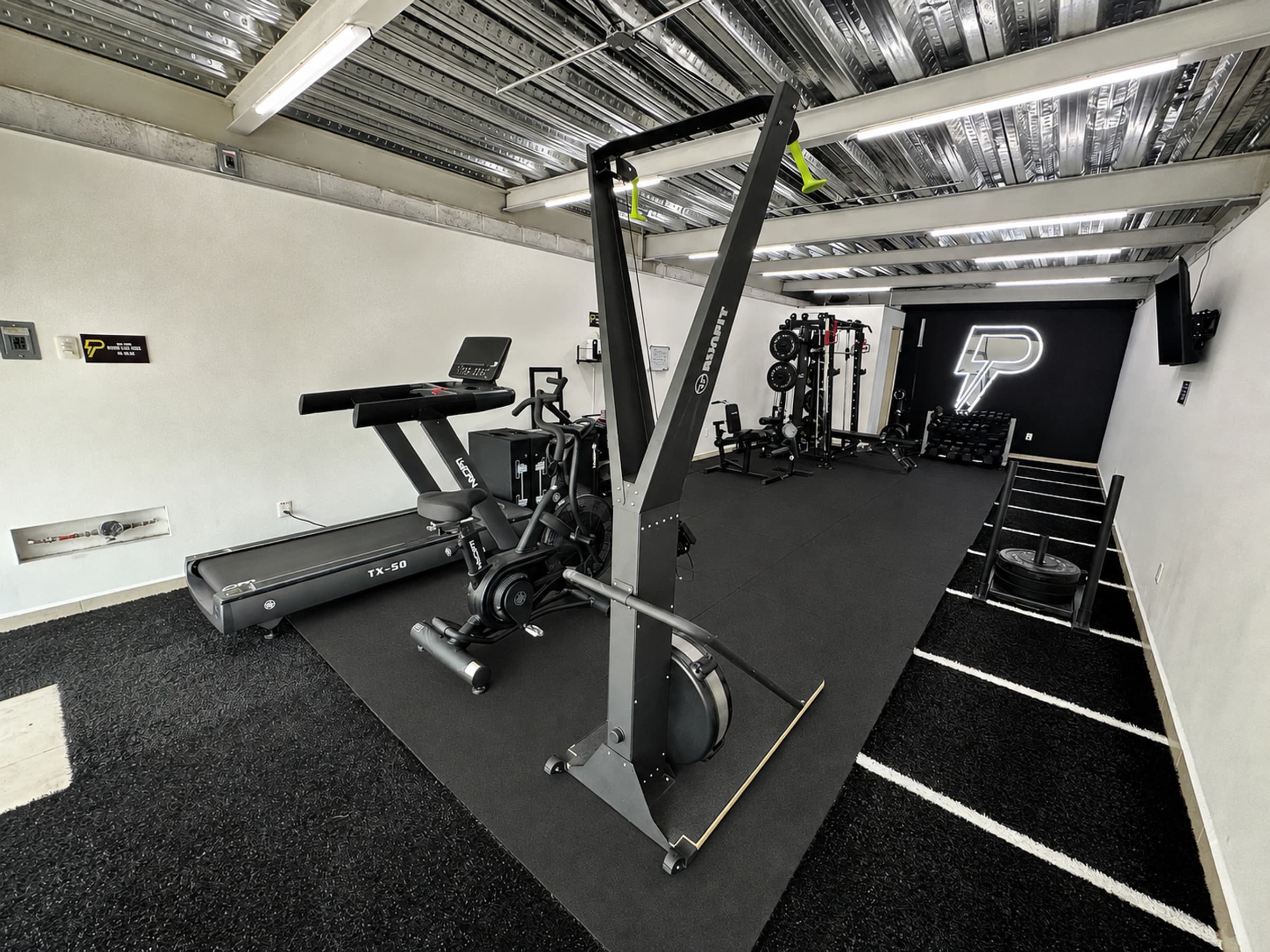FitPOD Vista Real private gym, with strength and cardio equipment and a sled track